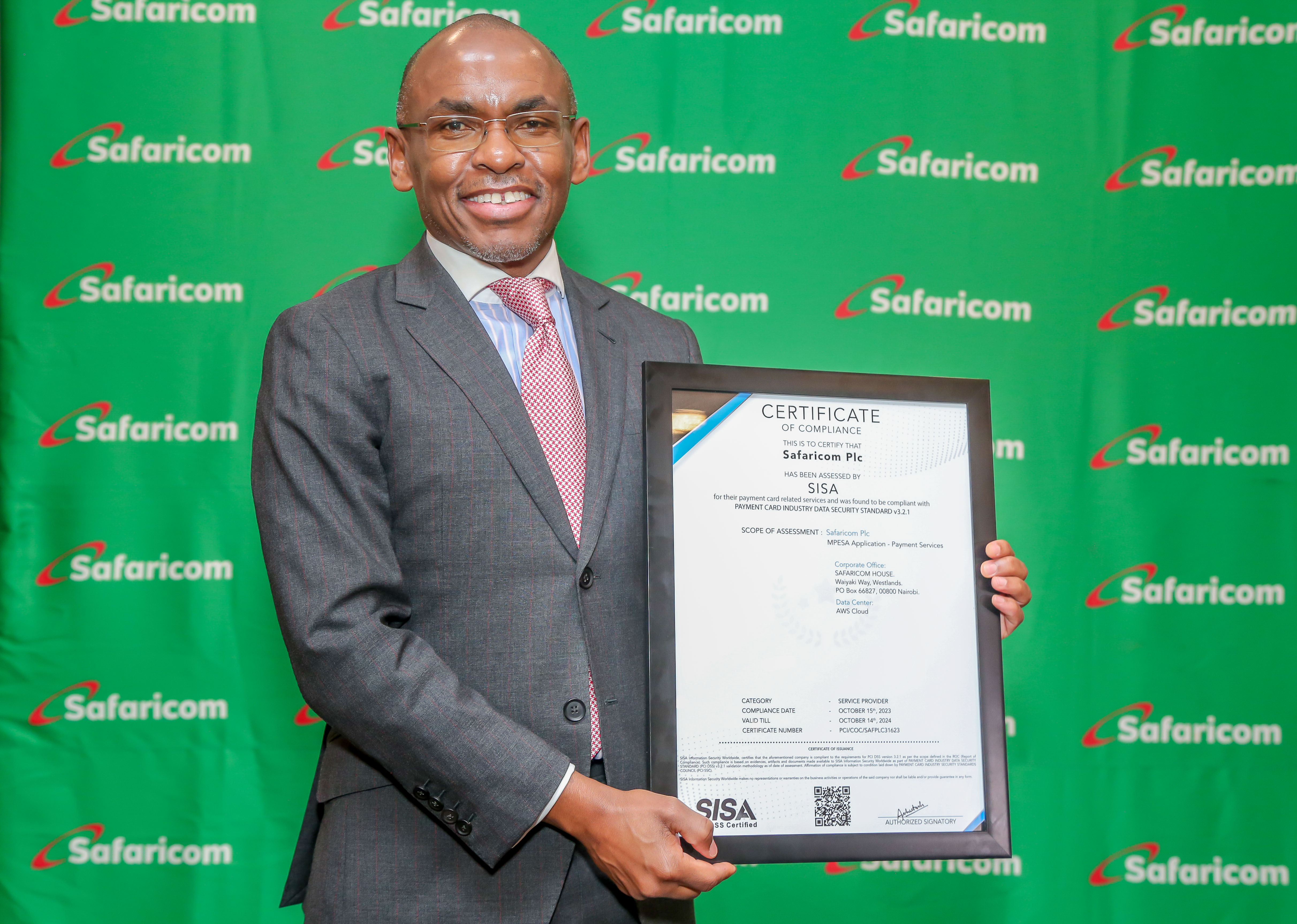 Safaricom CEO Peter Ndegwa receives a Certificate of compliance assessed by SISA for their payment card Industry Data Security Standard.